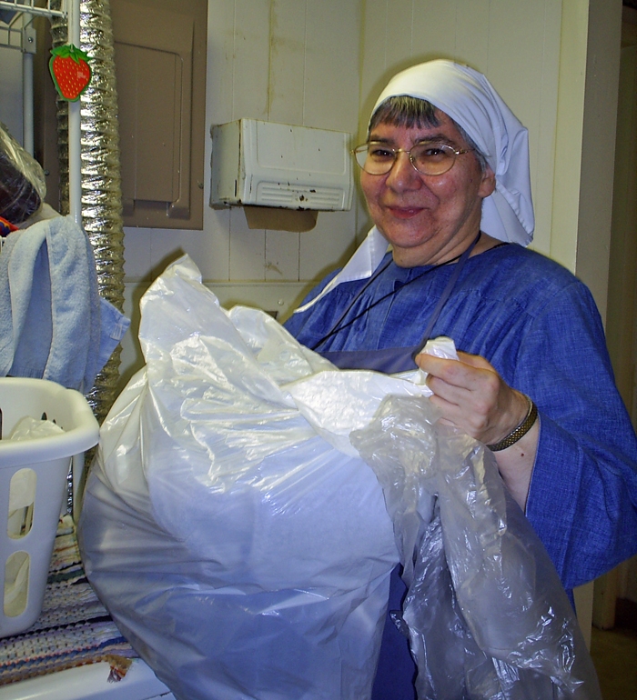 Sr. Joan (as a novice) washing the clothes of homeless men and women in the Hospitality Room of the Joseph House Crisis Center.